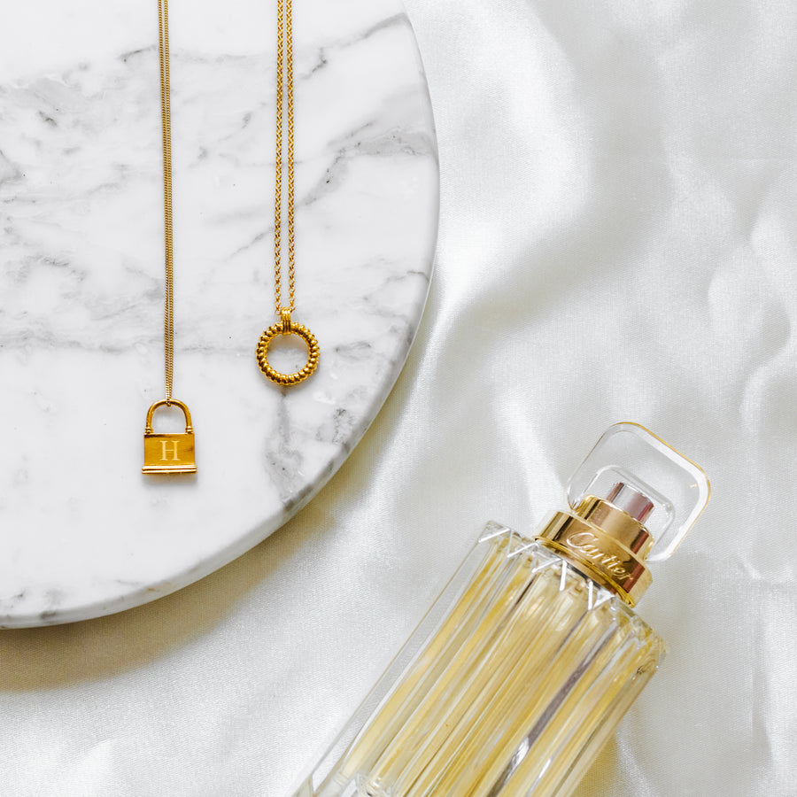gold necklaces marble perfume flat-lay styled image